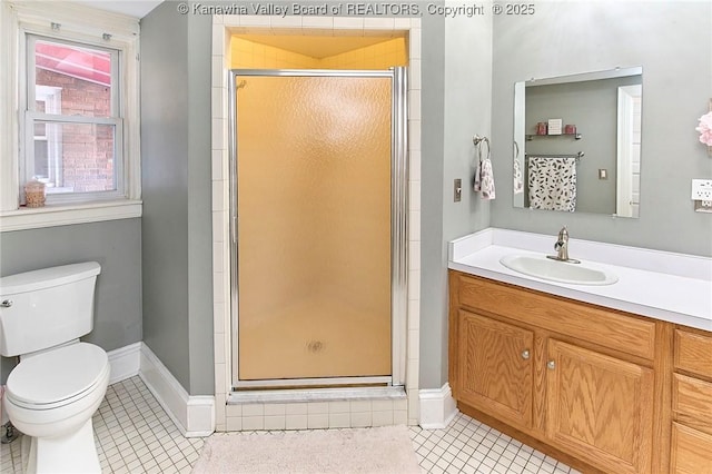 bathroom with a shower stall, baseboards, toilet, tile patterned floors, and vanity