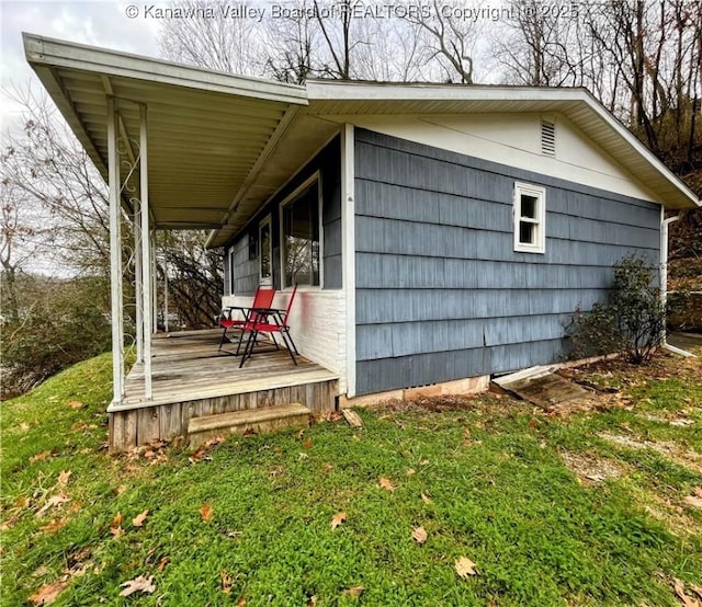 view of side of home with a lawn