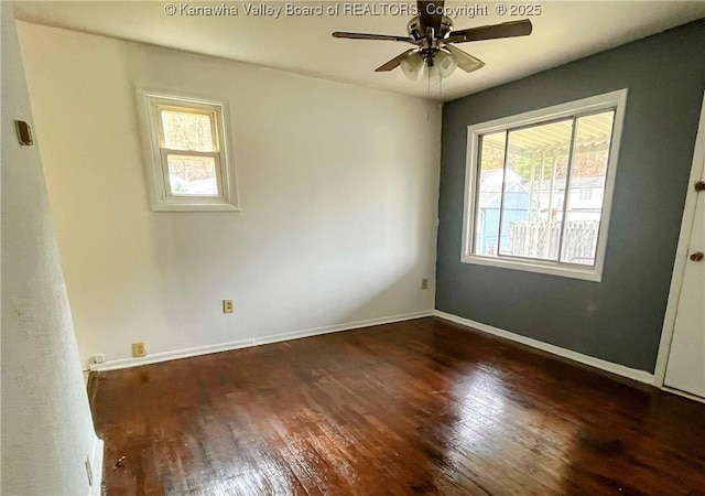 empty room with dark hardwood / wood-style floors and ceiling fan