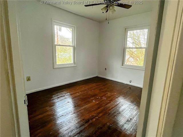 spare room with ceiling fan and dark hardwood / wood-style flooring