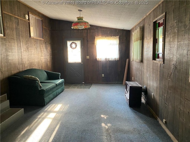 interior space with carpet flooring and wooden walls