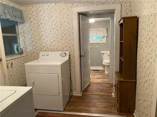 laundry area featuring dark hardwood / wood-style floors, washer / dryer, and crown molding