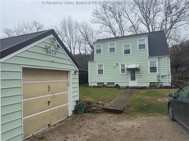 view of front of home with an outbuilding, a garage, and a front lawn