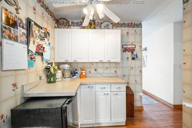 kitchen with white cabinets, ceiling fan, and hardwood / wood-style flooring