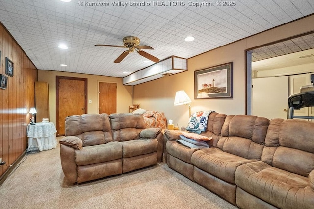 interior space featuring ceiling fan and wooden walls