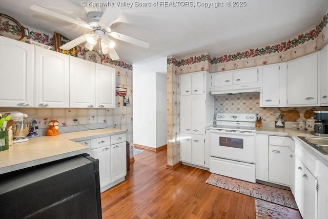 kitchen with tasteful backsplash, sink, white electric range, light hardwood / wood-style floors, and white cabinetry