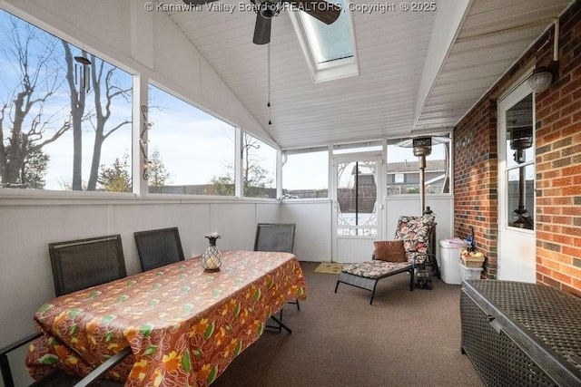 sunroom with lofted ceiling with skylight and ceiling fan