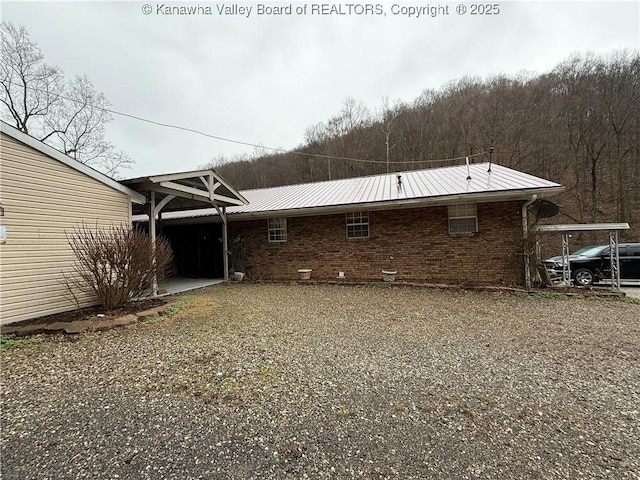 back of house featuring a carport