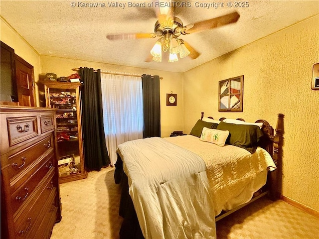 carpeted bedroom featuring a textured ceiling and ceiling fan