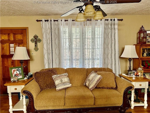 living room with wood-type flooring, a textured ceiling, and ceiling fan