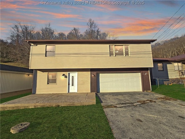 view of property featuring a yard and a garage