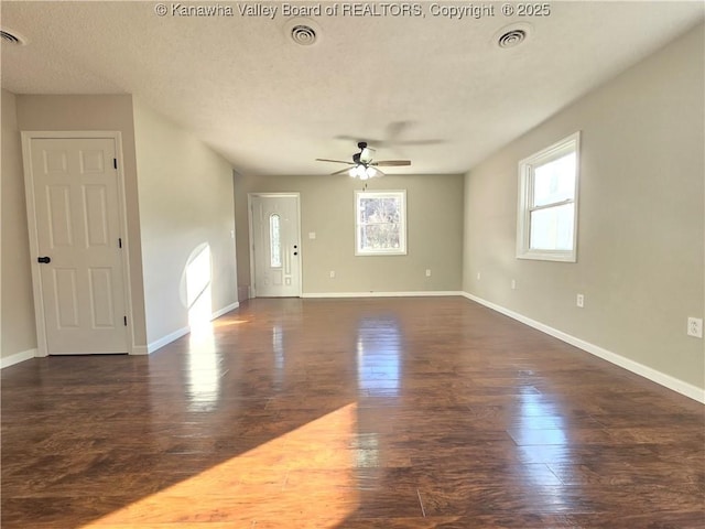 unfurnished room with ceiling fan and dark wood-type flooring