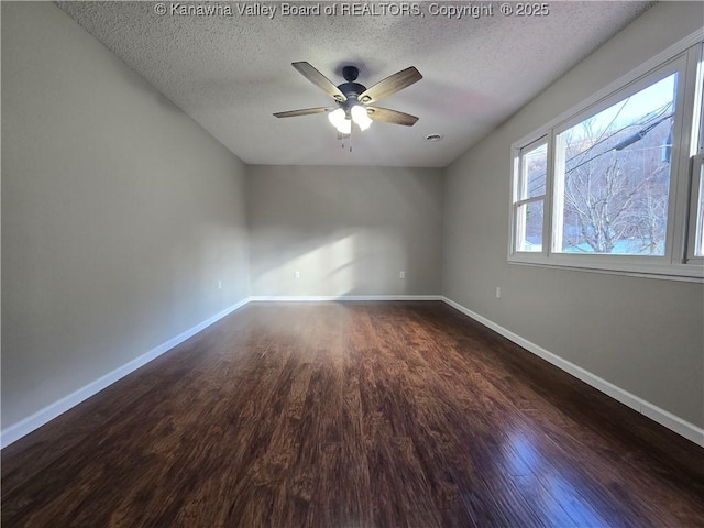 unfurnished room featuring dark hardwood / wood-style floors, ceiling fan, and a textured ceiling