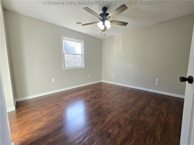 unfurnished room featuring a textured ceiling, ceiling fan, and dark wood-type flooring