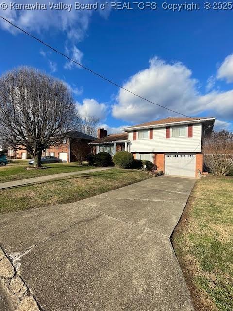 view of front of property with a garage and a front lawn