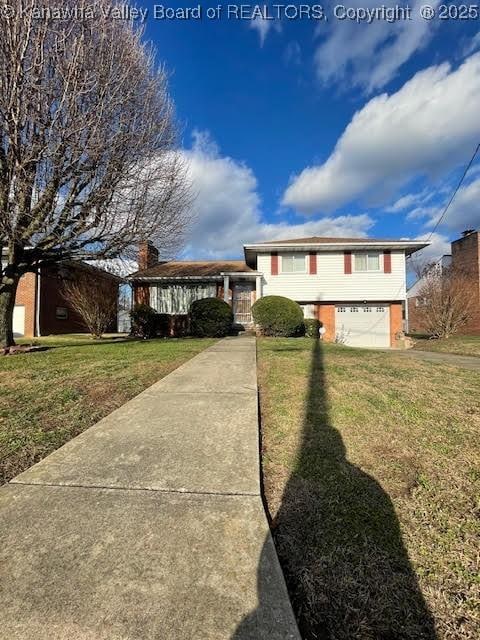 view of front of property with a garage and a front yard