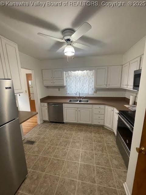 kitchen with ceiling fan, white cabinetry, sink, and appliances with stainless steel finishes