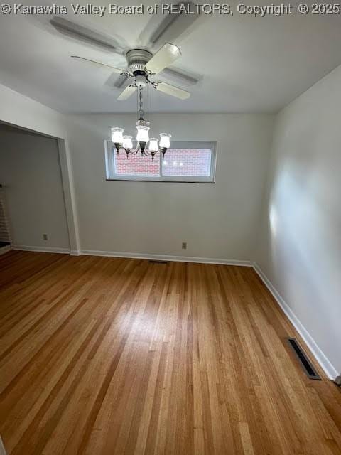 unfurnished room with a chandelier and light hardwood / wood-style flooring