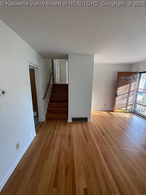 unfurnished living room with hardwood / wood-style flooring