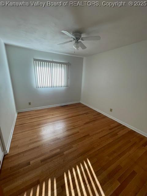 unfurnished room with hardwood / wood-style floors and ceiling fan