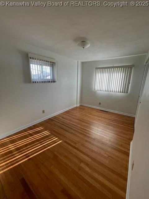 spare room with hardwood / wood-style flooring