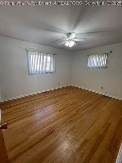 unfurnished room with ceiling fan and light wood-type flooring