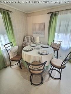 dining area with crown molding and plenty of natural light