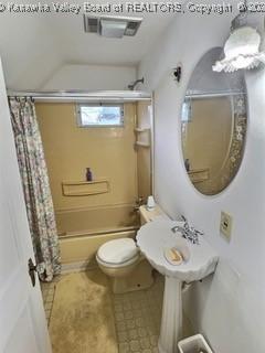 bathroom featuring tile patterned flooring, shower / bath combo, and toilet