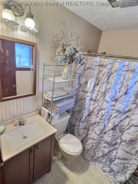 bathroom with vanity, a textured ceiling, toilet, and a shower with shower curtain