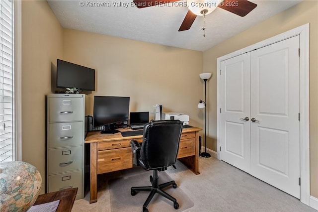 carpeted office with ceiling fan and a healthy amount of sunlight