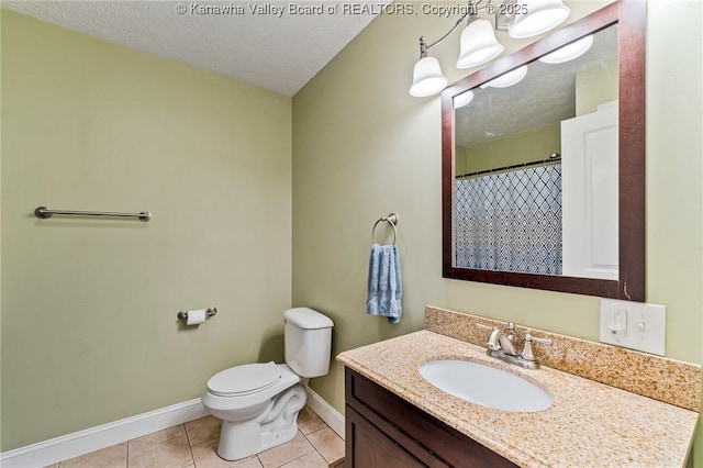 bathroom featuring tile patterned flooring, vanity, a textured ceiling, and toilet