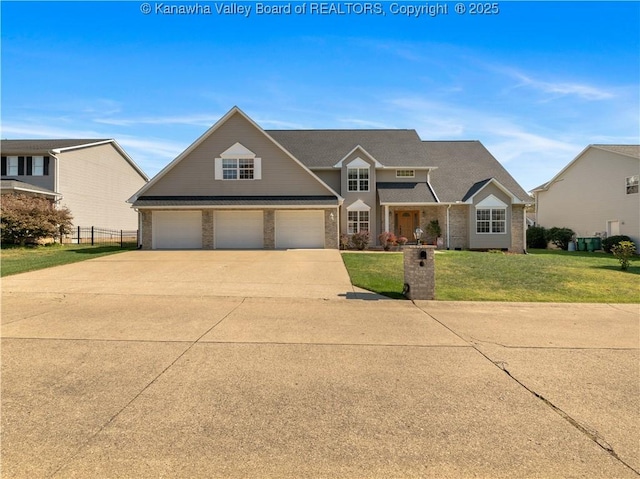 view of front of home featuring a front yard and a garage