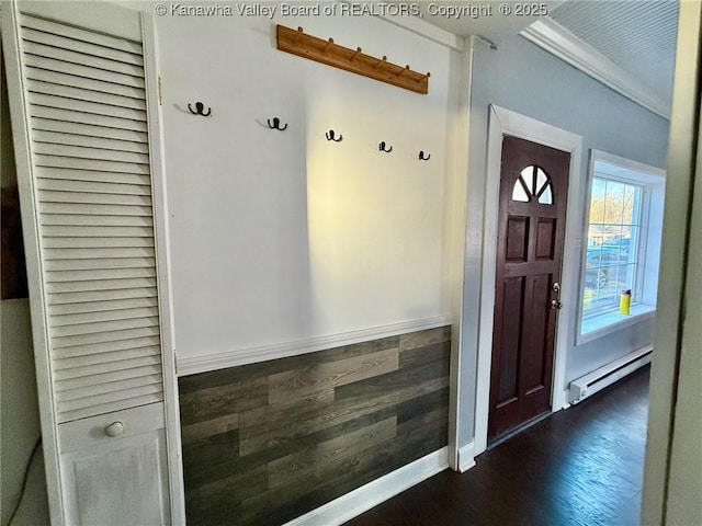 mudroom featuring crown molding, dark wood-type flooring, and a baseboard heating unit