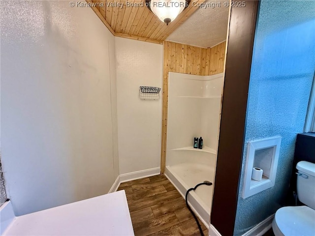 bathroom with hardwood / wood-style flooring, toilet, wood ceiling, and walk in shower