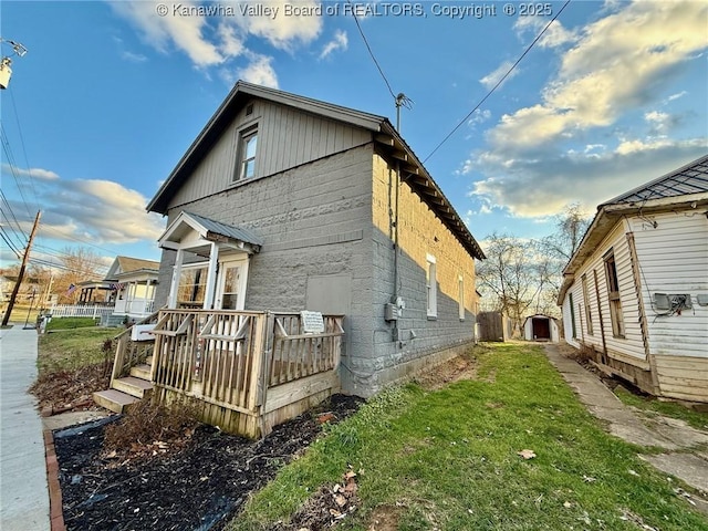 view of side of property with a lawn