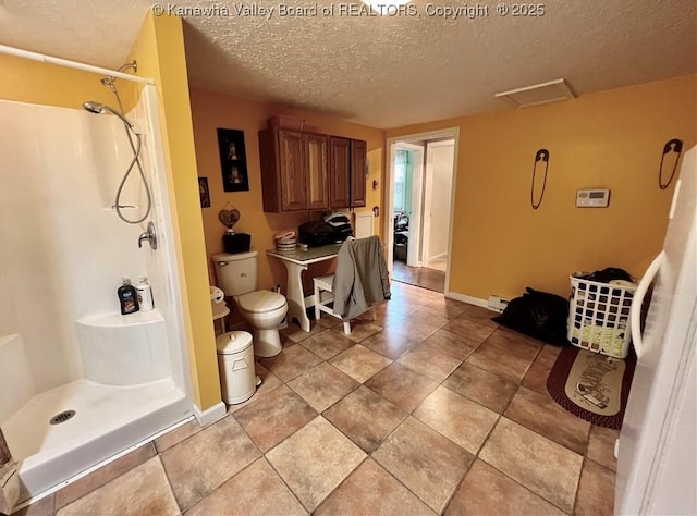 bathroom featuring baseboard heating, toilet, a textured ceiling, and walk in shower