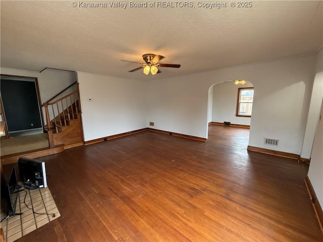 unfurnished living room featuring hardwood / wood-style flooring, a textured ceiling, and ceiling fan