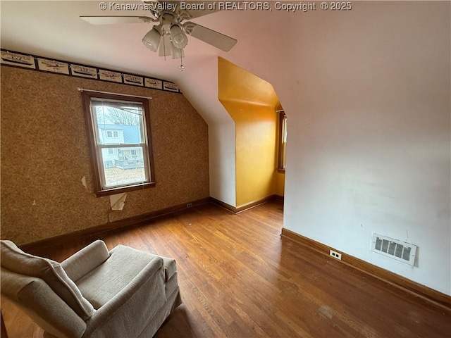 bonus room featuring wood-type flooring, lofted ceiling, and ceiling fan