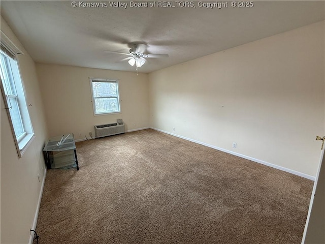 unfurnished room with a wall mounted air conditioner, carpet floors, and ceiling fan