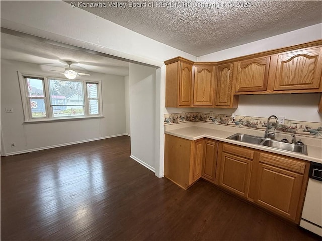 kitchen featuring sink, a textured ceiling, dark hardwood / wood-style flooring, dishwasher, and ceiling fan