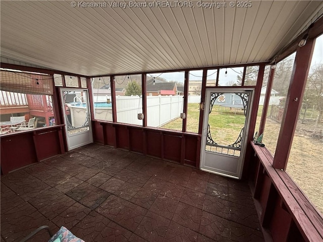 unfurnished sunroom with vaulted ceiling and wooden ceiling