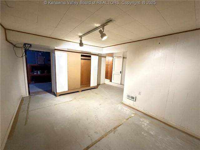 basement featuring rail lighting