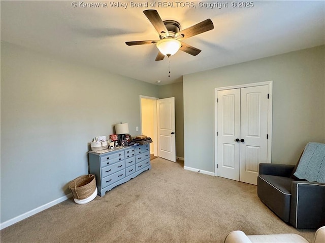 sitting room featuring light carpet and ceiling fan