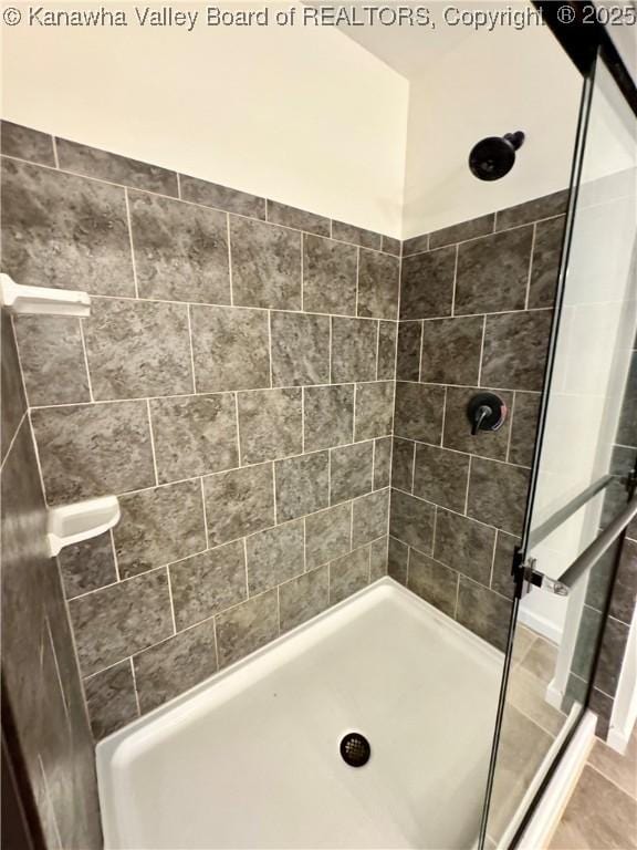 bathroom with tiled shower