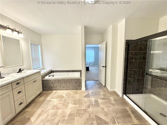 bathroom with vanity and separate shower and tub