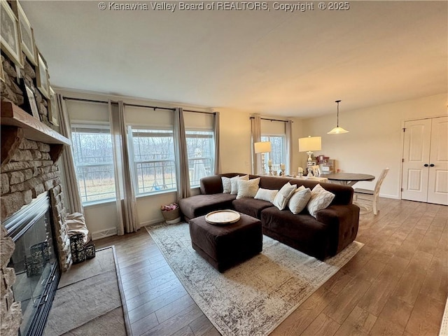 living room with hardwood / wood-style floors and a fireplace