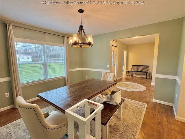 dining area with a chandelier and wood-type flooring