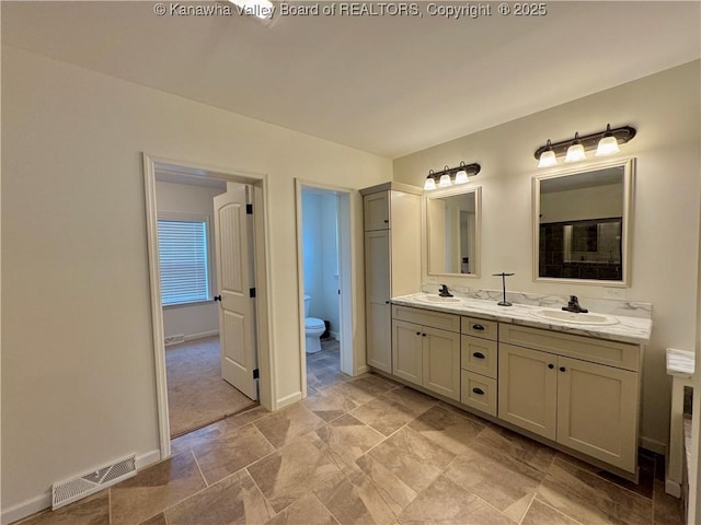 bathroom featuring vanity and toilet