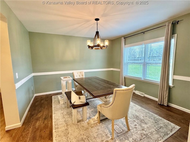 dining room featuring a chandelier and dark hardwood / wood-style flooring