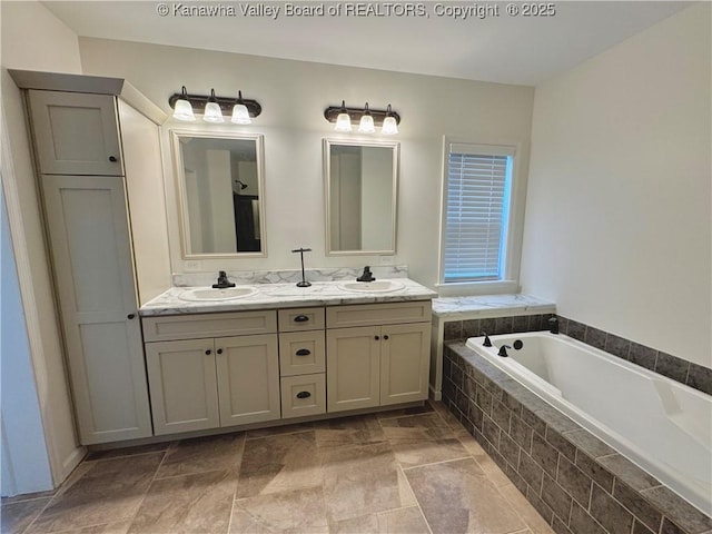 bathroom with vanity and tiled bath